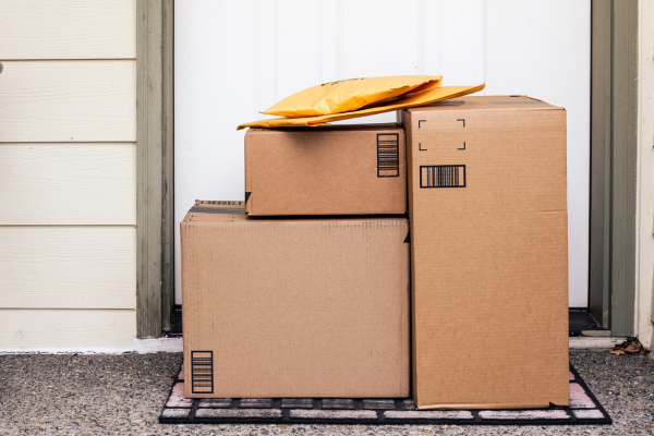 Packaged mail delivered in front of a door