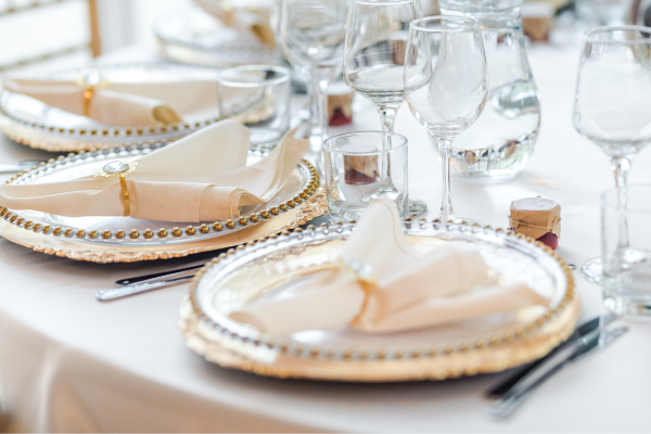 Wedding tables set up with glassware and linens at a venue