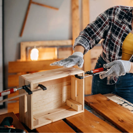 DIY RentalsPerson using clamps on wood