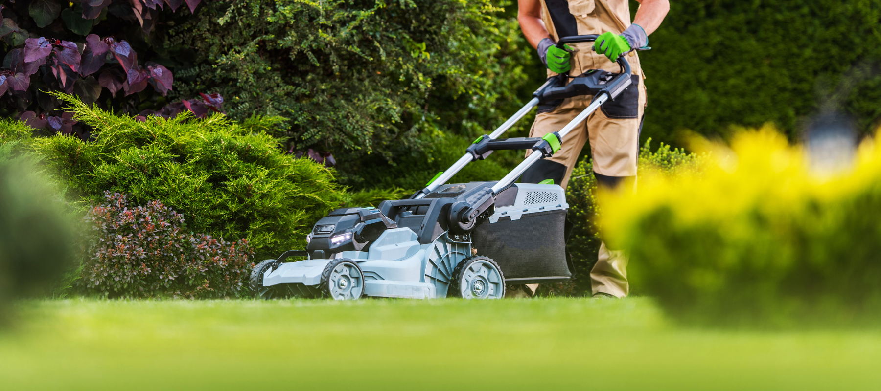 Landscaper pushing a lawn mower