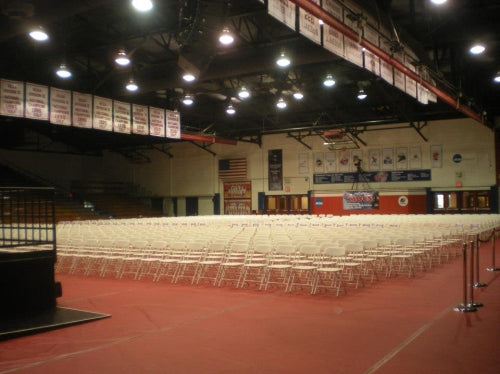 Event chairs set up inside of a gymnasium