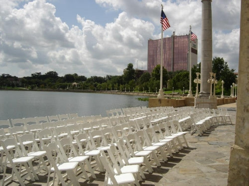 Event chairs set up next to a lake